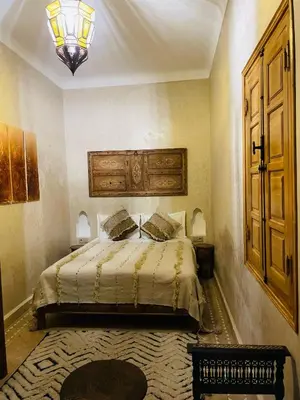 a bedroom with a bed and a chandelier at Riad Saadaoui in Marrakech