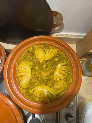 a bowl of food on a stove with a pot at Riad Saadaoui in Marrakech