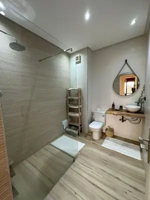 a bathroom with a toilet and a sink and a mirror at Luxury Appartement with Pool in Marrakech