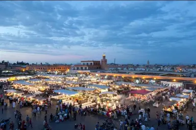 a crowd of people walking around a market at night at Luxury Appartement with Pool in Marrakech
