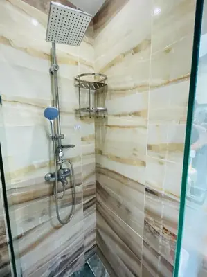 a shower with a glass door in a bathroom at Centre ville Majorelle avec Parking gratuit in Marrakech