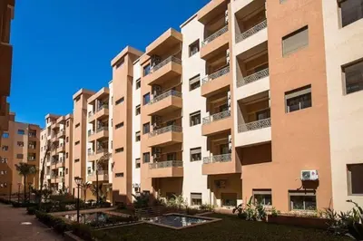 a large apartment building with balconies on a street at Charming two bedrooms Flat with Pool and Parking in Marrakech