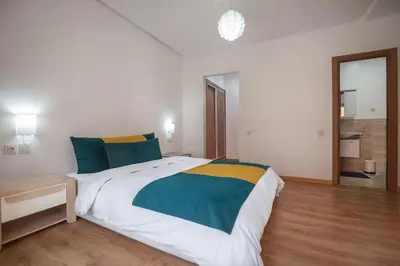 a bedroom with a large bed in a room at Charming two bedrooms Flat with Pool and Parking in Marrakech