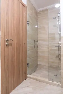 a shower with a glass door in a bathroom at Spacious 2 BR FLAT with Wi-Fi, Pool and Parking in Marrakech