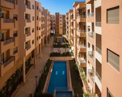 an aerial view of an apartment complex with a swimming pool at Spacious 2 BR FLAT with Wi-Fi, Pool and Parking in Marrakech