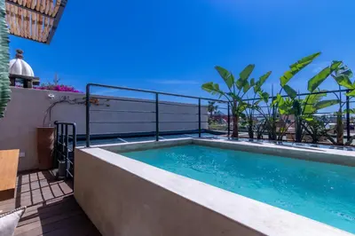 a swimming pool on the roof of a house at Riad Doum Collection 2 in Marrakech
