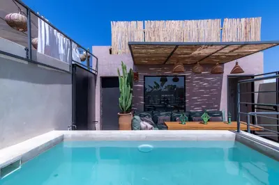a swimming pool in the backyard of a house at Riad Doum Collection 2 in Marrakech