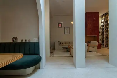 a living room with a green couch and a living room at Riad & Spa, Doum Collection in Marrakech