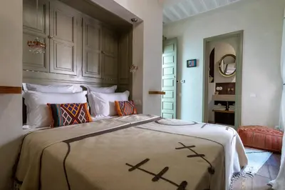 a bedroom with a large bed in a room at Riad & Spa, Doum Collection in Marrakech