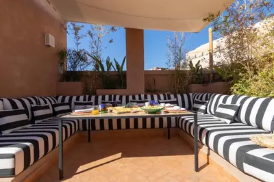 a patio with a table with plates of food on it at Riad & Spa, Doum Collection in Marrakech