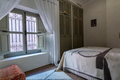 a bedroom with a bed and a window at Riad & Spa, Doum Collection in Marrakech