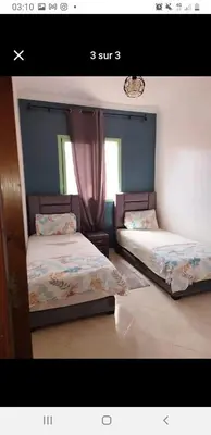 two beds in a room with a window at Marrakech in Marrakech