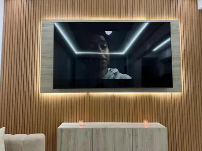 a television on a wall with a woman on it at Appartement Cosy in Marrakech