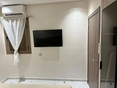 a flat screen tv on the wall of a room at Appartement Cosy in Marrakech