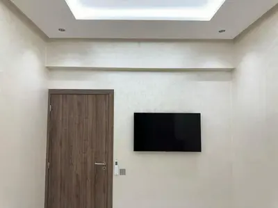a room with a door and a television on the wall at Appartement Cosy in Marrakech
