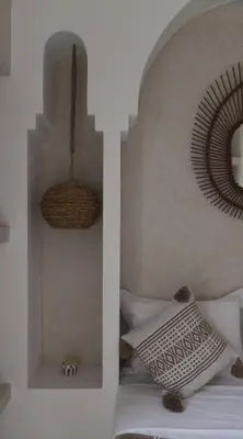 a bedroom with a bed with white pillows at Riad Soulmate in Marrakech