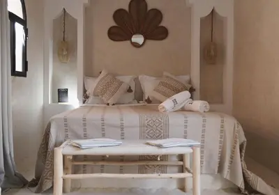 a bedroom with a white bed with pillows on it at Riad Soulmate in Marrakech