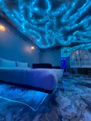 a bed in a room with a ceiling covered in clouds at Tête dans les nuages ! Jacuzzi in Marrakech