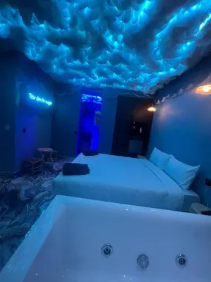 a room with two beds and a bath tub at Tête dans les nuages ! Jacuzzi in Marrakech