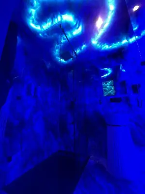 a dark room with blue lights on the ceiling at Tête dans les nuages ! Jacuzzi in Marrakech