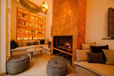 a living room with a fireplace and a couch at Door Janna in Marrakech