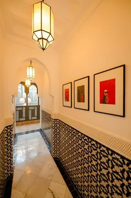 a hallway with art on the wall and a chandelier at Door Janna in Marrakech