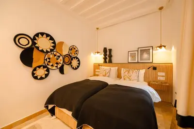 a bedroom with a large bed and some clocks on the wall at Door Janna in Marrakech