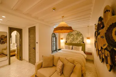 a bedroom with a large bed and a couch at Door Janna in Marrakech