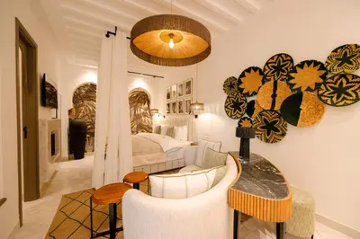 a bedroom with a bed and a table and chairs at Door Janna in Marrakech