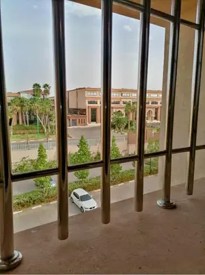 a white car parked outside of a window at Un élégant appartement à louer à Marrakech avec deux piscines et une situation en centre ville in Marrakech
