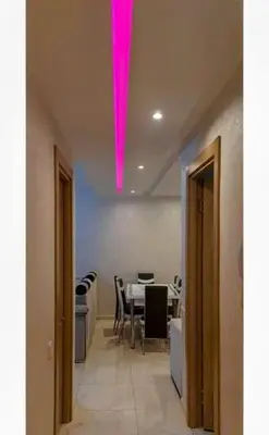 a pink light hanging from a ceiling in a room at Un élégant appartement à louer à Marrakech avec deux piscines et une situation en centre ville in Marrakech