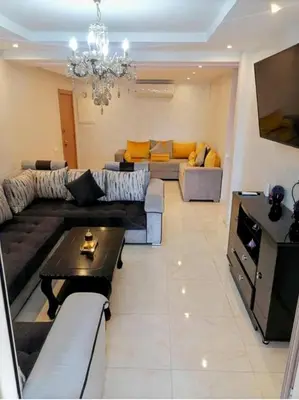 a living room with a couch and a table at Appartement calme et élégant au coeur de Marrakech in Marrakech