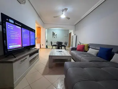a living room with a large flat screen tv at Appartement Chic au Coeur Gueliz Marrakech in Marrakech