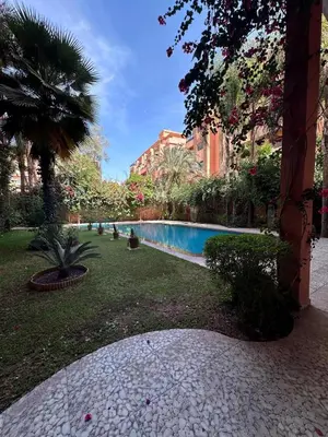 a courtyard with a swimming pool in a building at Magnifique appartement 2 chambres et piscine de standing in Marrakech