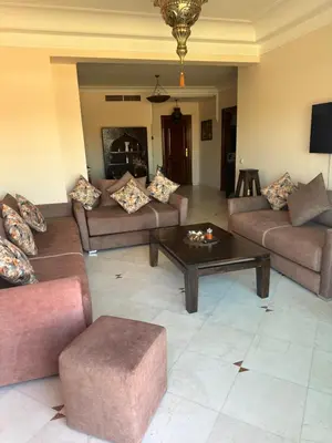 a living room with couches and a coffee table at Magnifique appartement 2 chambres et piscine de standing in Marrakech
