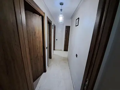 a hallway with wooden doors and a tile floor at Appartement Nour 5 Marrakech in Marrakech