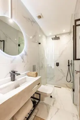 a white bathroom with a sink and a shower at New Duplex Haut Standing à Victor Hugo, Gueliz in Marrakech