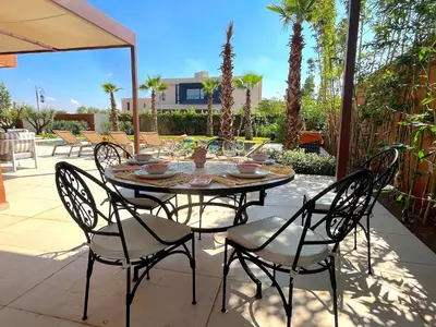 a table and chairs on a patio at Palais Siham in Marrakech
