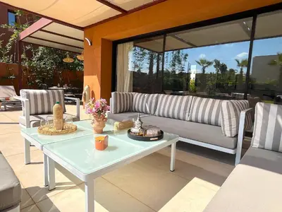 a living room with a table and a couch at Palais Siham in Marrakech
