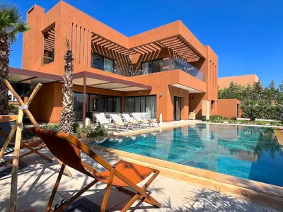 a house with a swimming pool in front of a house at Palais Siham in Marrakech