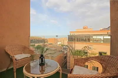 a table and chairs on a balcony with a view at Elegant and Brand new appart in hypercenter of Marrakech in Marrakech
