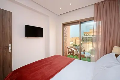 a hotel room with a bed and a large window at Elegant and Brand new appart in hypercenter of Marrakech in Marrakech