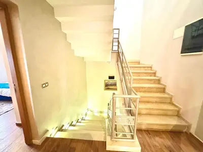 a staircase in a home with wooden floors at Villa des Ocres - Élégance et Luxe à 15 min du centre ! in Marrakech