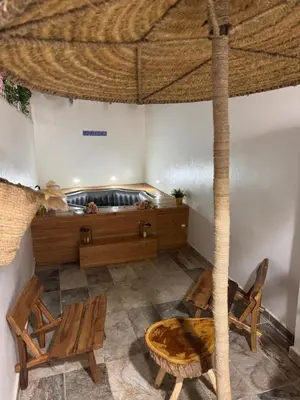 a room with a bed and a table and chairs at Duplex au cœur de marrakech in Marrakech