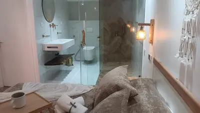 a bathroom with a sink and a glass shower at Duplex au cœur de marrakech in Marrakech