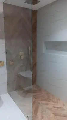 a bathroom with a glass shower with a toilet at Duplex au cœur de marrakech in Marrakech