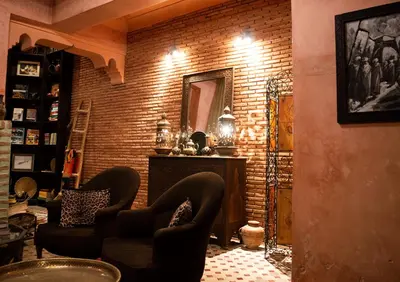 a living room with two chairs and a mirror at Riad Amirat Al Jamal in Marrakech