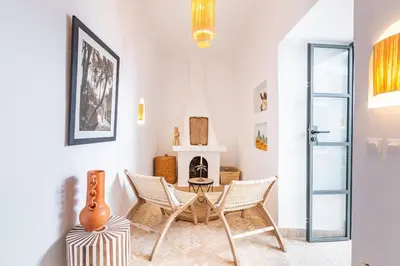 a living room with chairs and a table and a guitar at Riad Belvi - Breakfast - 10mn Jemaa El Fnaa-Pool in Marrakech