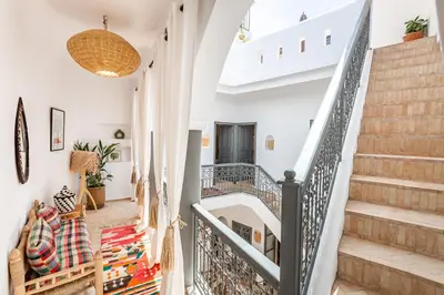 a staircase in a home with white walls and a white ceiling at Riad Belvi - Breakfast - 10mn Jemaa El Fnaa-Pool in Marrakech