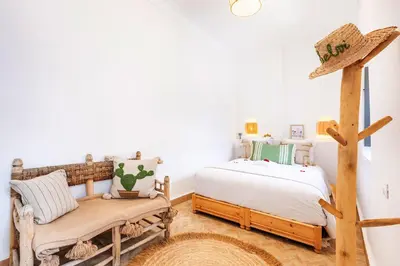 a bedroom with a bed and a chair at Riad Belvi - Breakfast - 10mn Jemaa El Fnaa-Pool in Marrakech